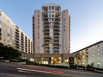 a large apartment building on a city street at night